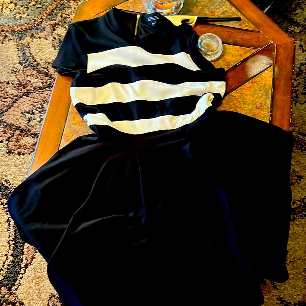 Beautiful dress. Black and white. Gold zipper. Has pockets. Size 12, midi length